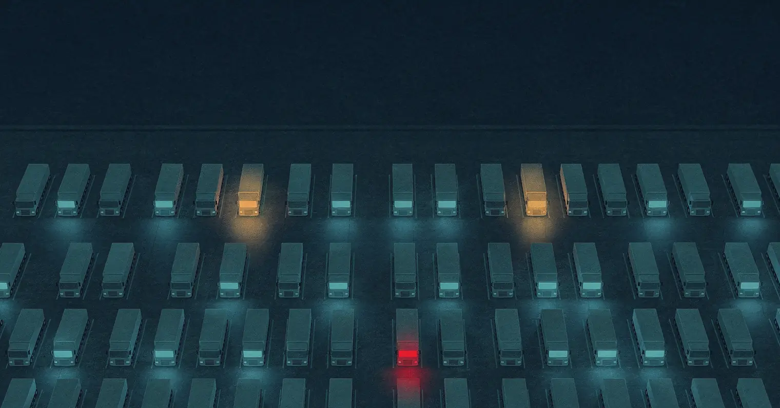 Illustration: rows of parked trucks seen from above at night, a few glowing amber and one red among the rest